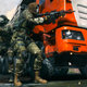 A squad of soldiers gathers behind a truck in Call of Duty.